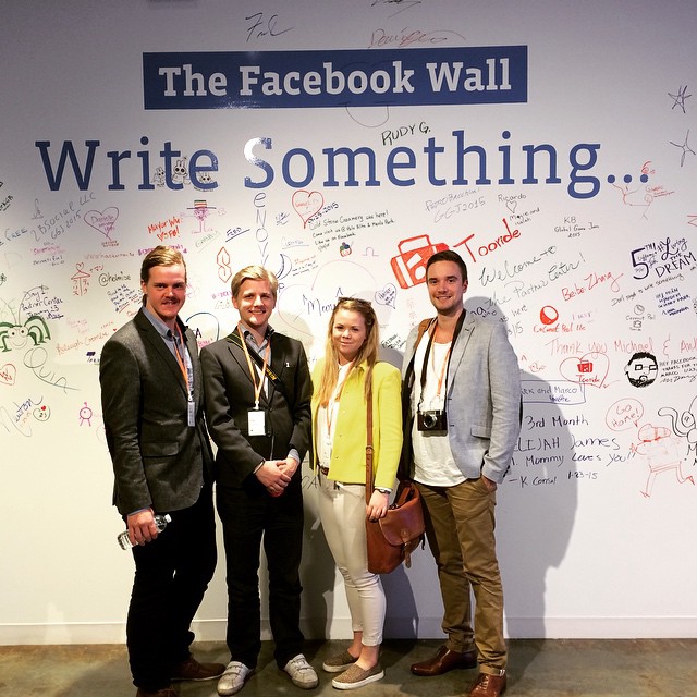 The winners infront of the physical facebook wall